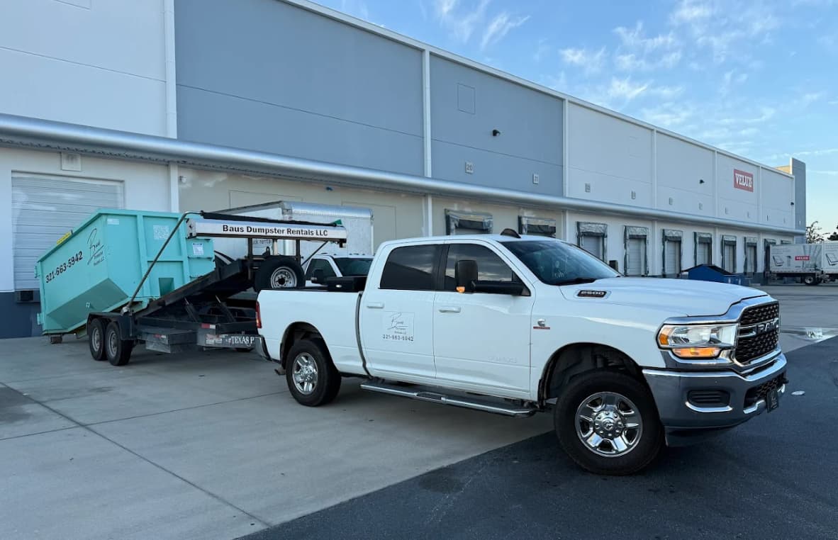 Baus pickup truck and roll-off trailer at a commercial warehouse in Orlando, FL