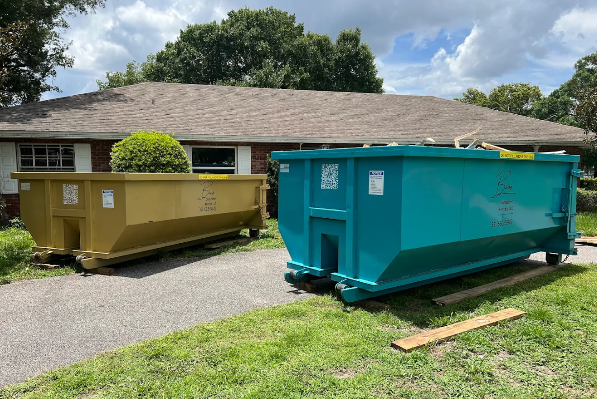 Yellow and teal Baus roll-off dumpsters at a home in Orlando, FL