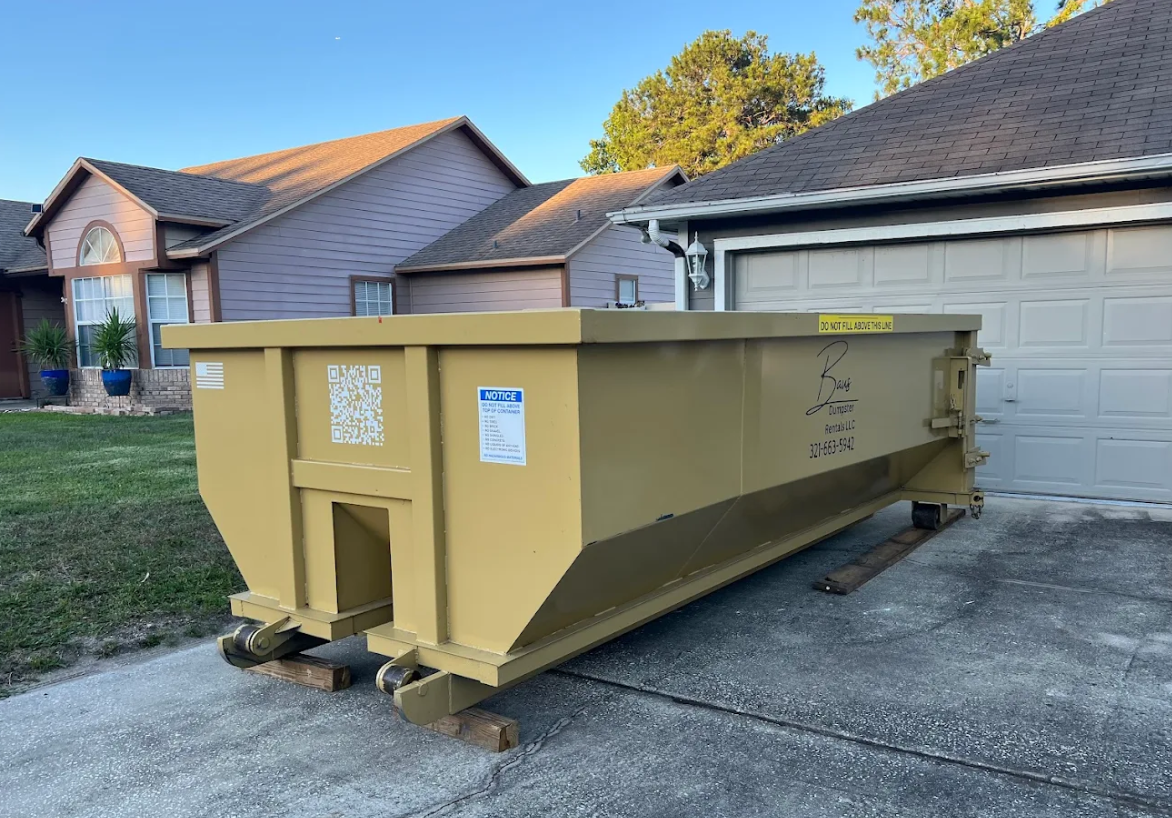 Yellow Baus 15 yard dumpster at a home in Orlando, FL