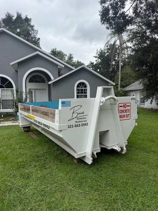 White Baus 7 yard heavy duty dumpster on a driveway in Kissimmee, FL