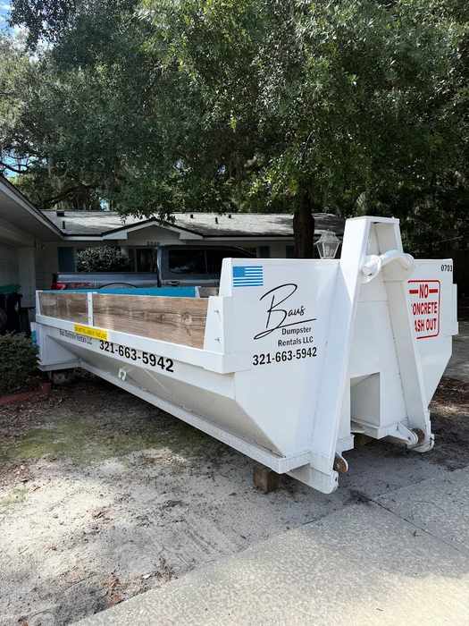 White Baus 7 yard heavy duty dumpster on a residential lot in Winter Park, FL